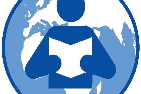 image of a person holding a book, against the map of the world